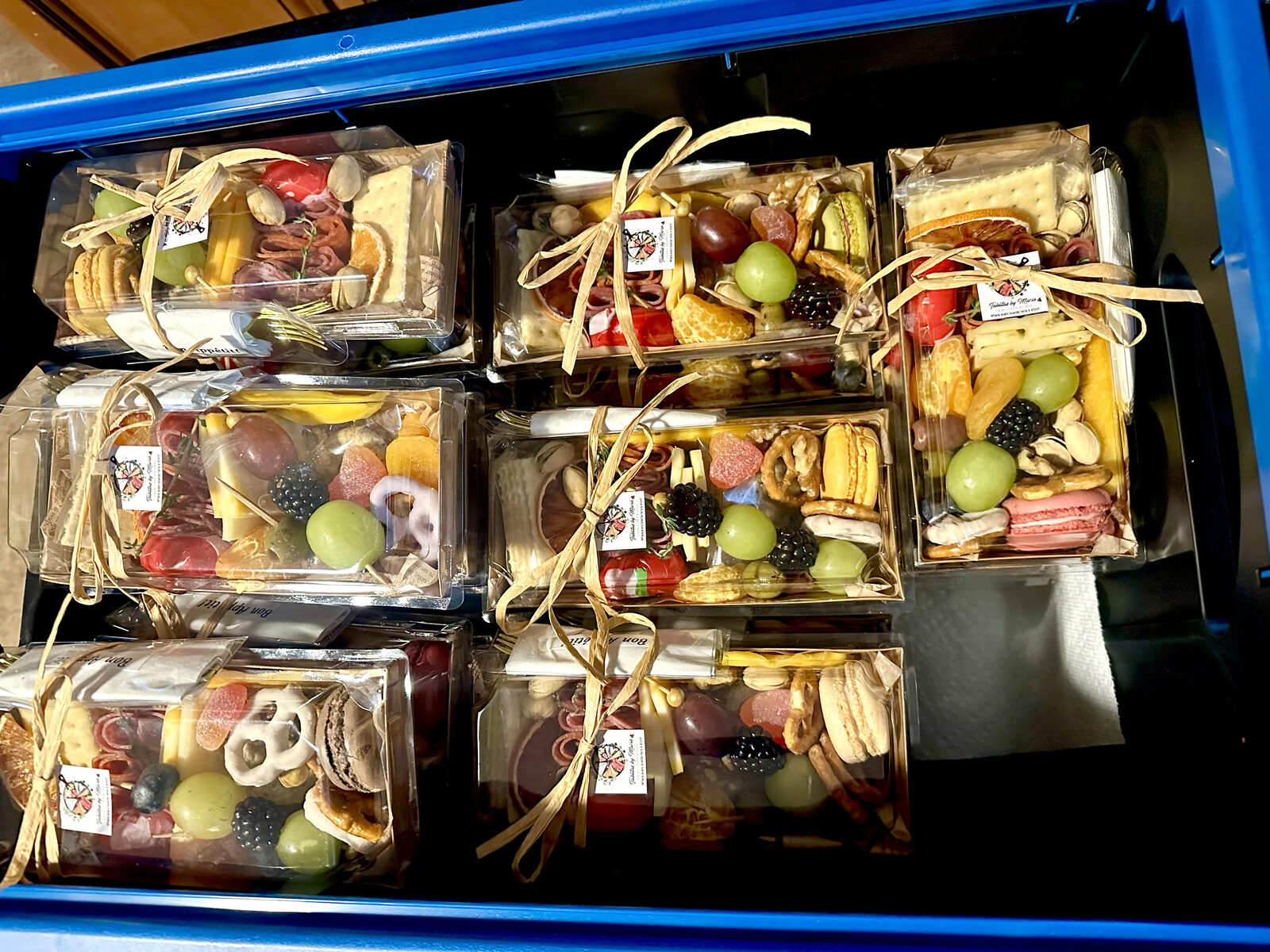 Crate of personal charcuterie boxes ready for an event